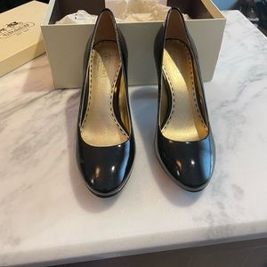 BRAND NEW. STILL IN BOX. Coach Black Patent Leather pumps.